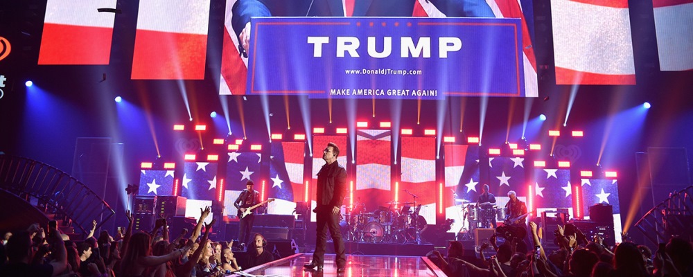 LAS VEGAS, NV - SEPTEMBER 23: An image of businessman/politician Donald J. Trump is projected on a screen while recording artists (from L) The Edge, Bono, Larry Mullen Jr., and Adam Clayton of music group U2 perform onstage at the 2016 iHeartRadio Music Festival at T-Mobile Arena on September 23, 2016 in Las Vegas, Nevada.  (Photo by John Shearer/Getty Images for iHeartMedia)